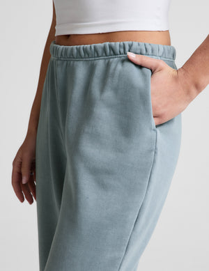 Ice blue Fade Out Mid-Rise Sweatpant showing the gathered elastic waistband and side slant pocket with a hand inside.