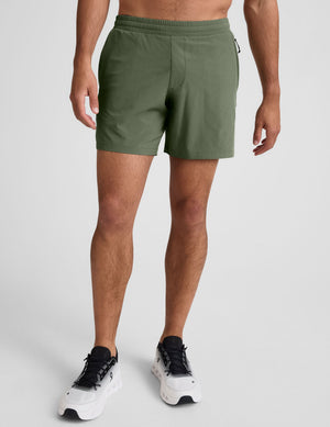 A man wearing olive Pivotal 2.0 Men's Lined Short 7