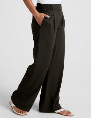 Side view of person wearing Status Wide Leg Trouser in olive green with elastic waistband, side pockets, and relaxed fit.