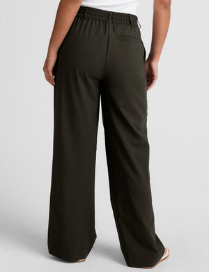 Back view of the olive Status Wide Leg Trouser featuring an elasticated waistband and a flowy wide-leg silhouette.