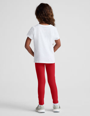 Back view of a toddler in full-length, bright red Spacedye Toddler Leggings with a snug fit, white t-shirt, and sneakers.