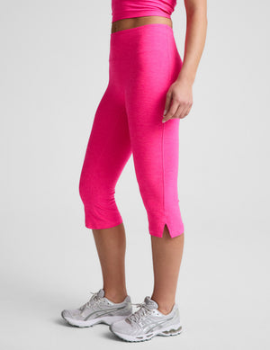 Bright pink Spacedye Mid-Rise Slit Pedal Pusher Legging. Snug, mid-calf length with a side hem slit, shown from the side.